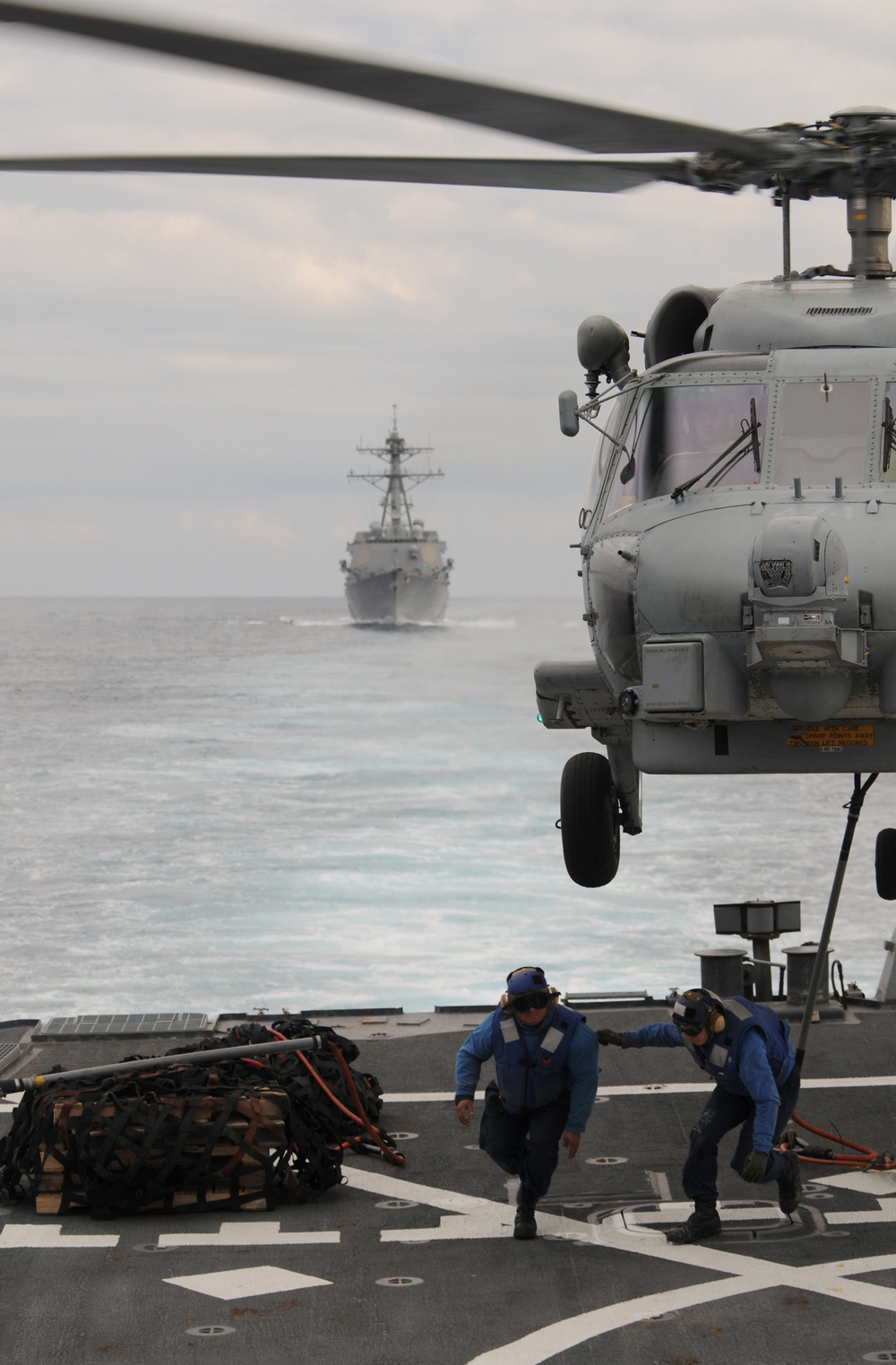 Seaman Lucio Robles and Seaman Daniel Nogal clear the flight deck.
