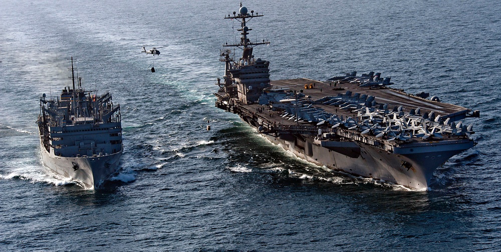 The aircraft carrier USS John C. Stennis (CVN 74) is underway alongside the Military Sealift Command fast combat support ship USNS Rainier (T-AOE 7).