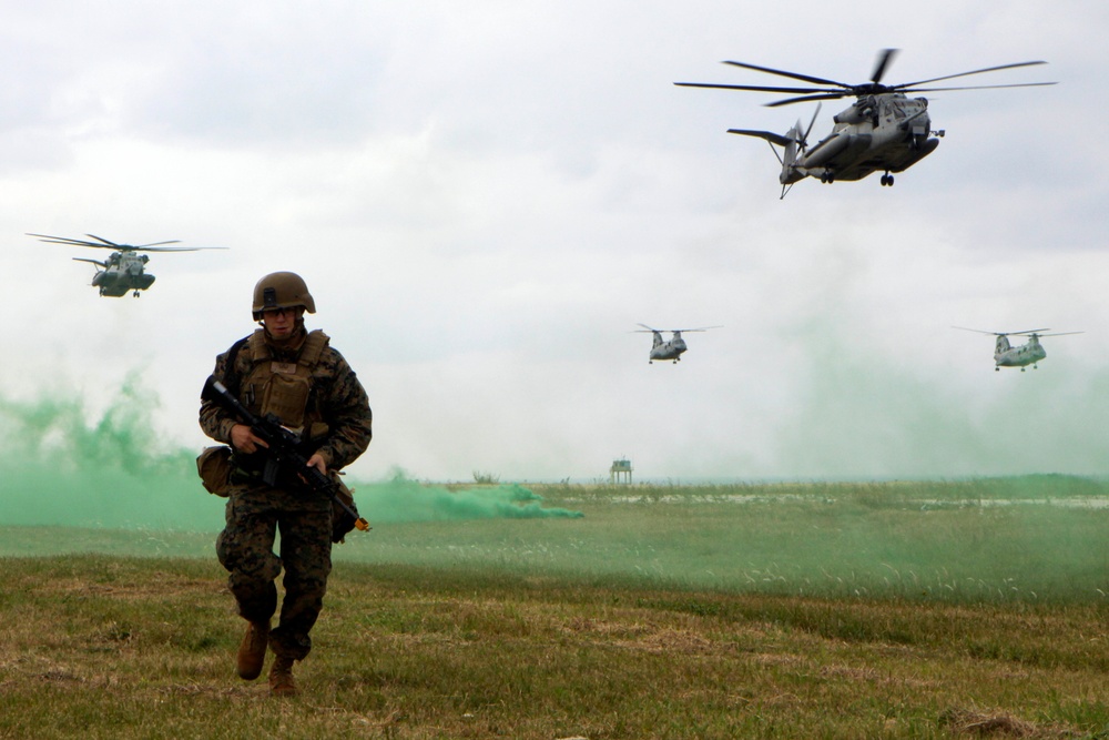 Sgt. Donald Christensen moves into position as helicopters prepare to land.
