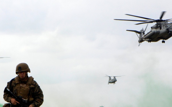 Sgt. Donald Christensen moves into position as helicopters prepare to land.