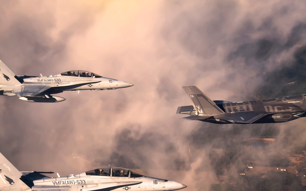 A U.S. Marine Corps F-35 Lightening II aircraft is escorted as it flies toward Eglin Air Force Base.