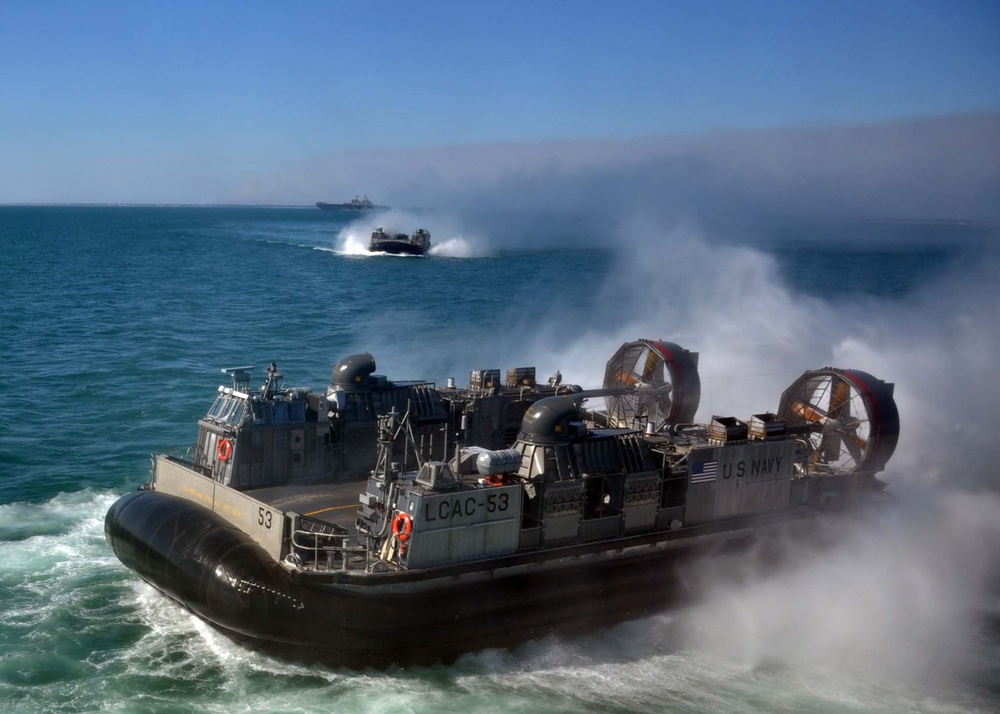 U.S. Navy Landing Craft, Air Cushion 53 approaches the well deck of the amphibious transport dock ship USS San Antonio (LPD 17).