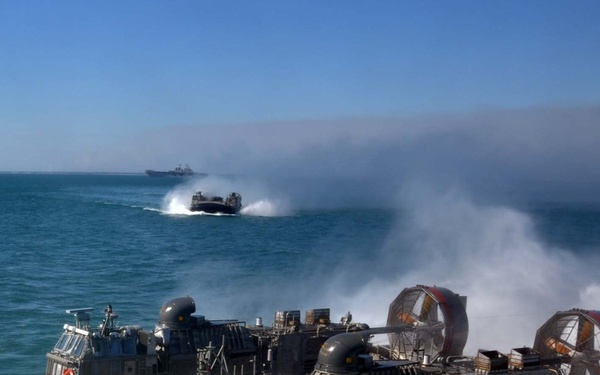 U.S. Navy Landing Craft, Air Cushion 53 approaches the well deck of the amphibious transport dock ship USS San Antonio (LPD 17).