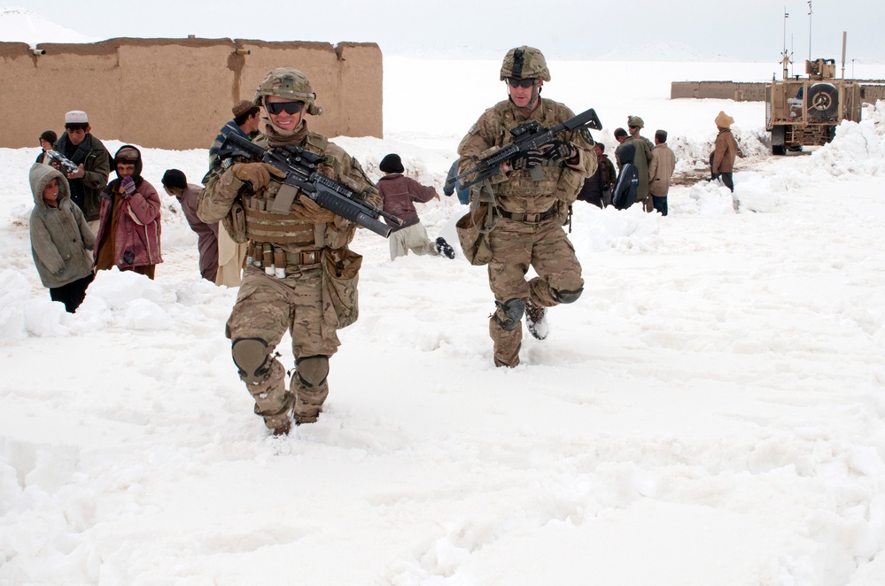 Sgt. Nick Lightwine and Sgt. Rob Logue make their way to their Mine Resistant Ambush Protected truck.