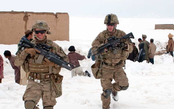 Sgt. Nick Lightwine and Sgt. Rob Logue make their way to their Mine Resistant Ambush Protected truck.