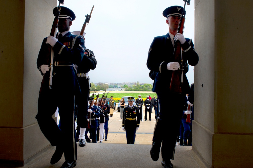 Soldiers, sailors, Marines, airmen and Coast Guardsmen position themselves to conduct an honor cordon.