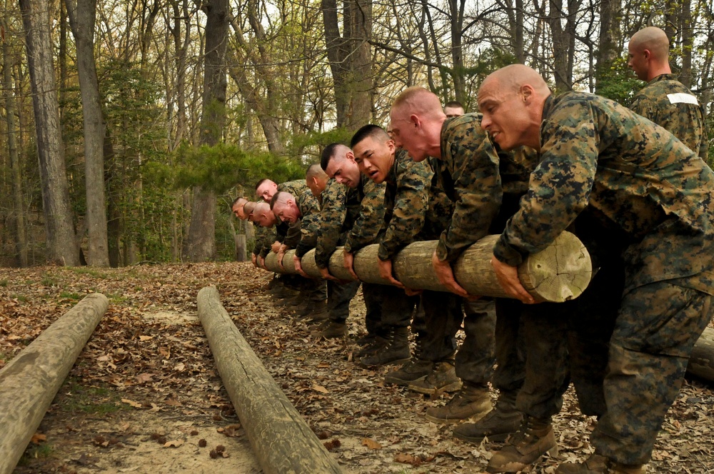 U.S. Marine Corps officer candidates lift a 300-pound log.