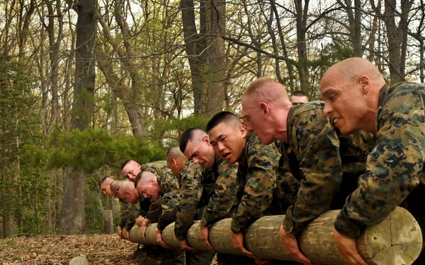 U.S. Marine Corps officer candidates lift a 300-pound log.
