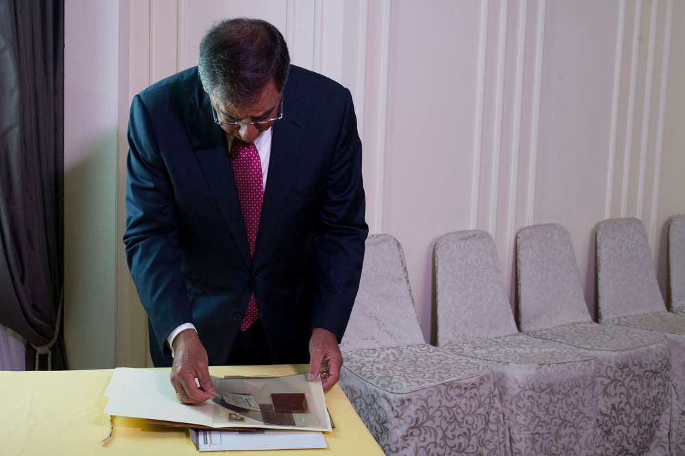 Secretary Panetta looks through a diary that once belonged to Vietnamese soldier Vu Dinh Doan