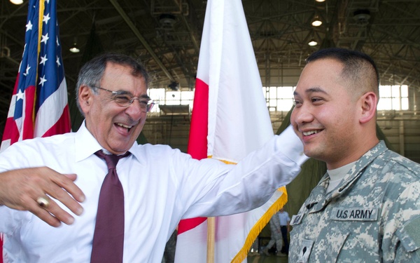 Secretary Panetta laughs with a soldier at Yokota Air Base