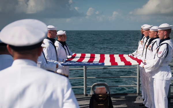 Members of the U.S. Navy Ceremonial Guard hold an American flag over the remains of Apollo 11 astronaut Neil Armstrong