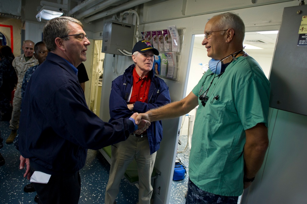 Deputy Secretary Carter and Navy Secretary Mabus greet Lt. Cmdr. Howard Hall onboard the USS Makin Island