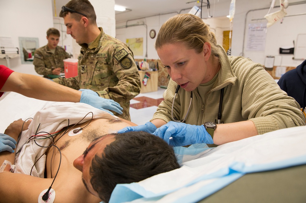 Lt. j.g. Laura Cook evaluates a wounded Afghan policeman