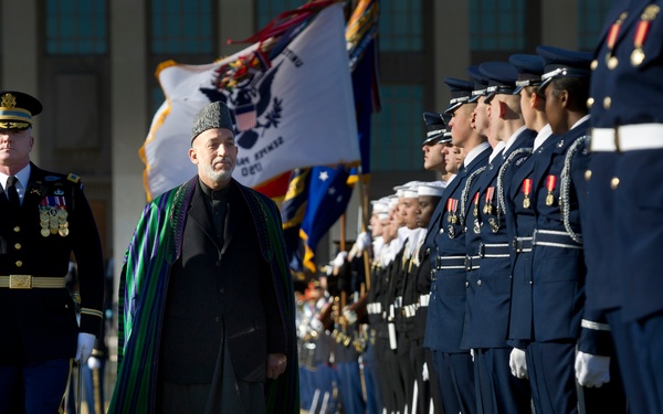 Col. James Markert escorts Afghanistan's President Hamid Karzai as he inspects the troops in formation