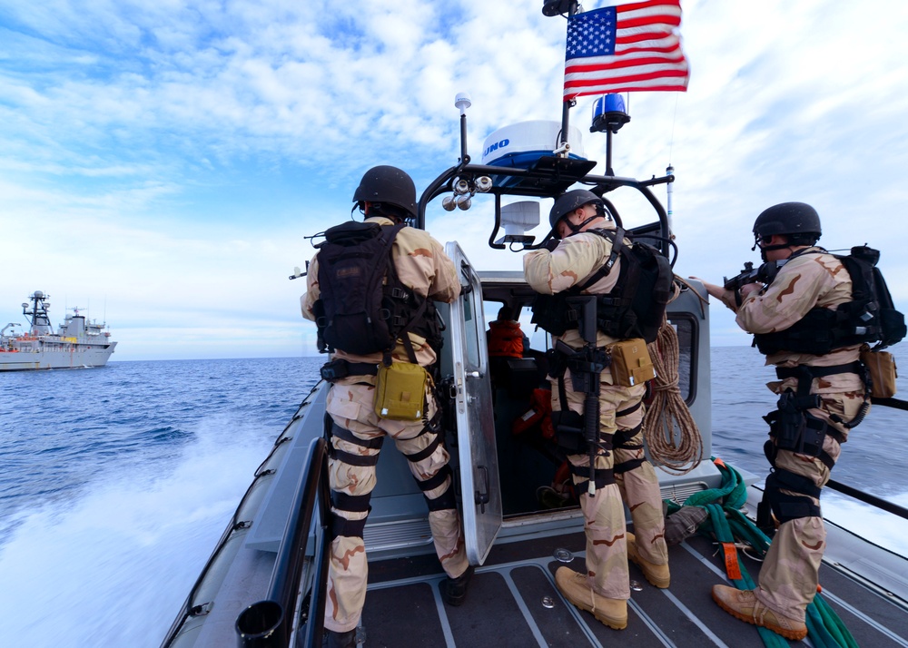 Sailors on a visit, board, search and seizure team race across the Atlantic Ocean