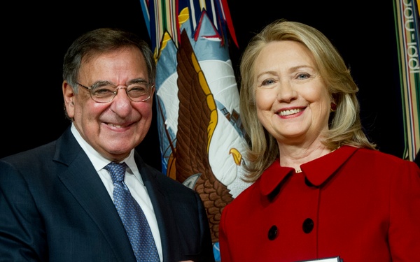 Secretary Panetta presents former Secretary Clinton with a medal