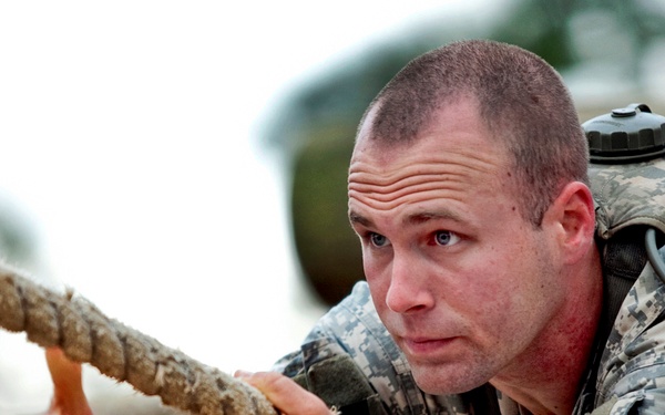 Army 2nd Lt. Marin Lohn pulls himself along a rope