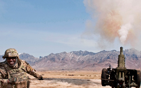 Sgt. 1st Class Fredrick Edwards yanks a lanyard to test fire a D-30 howitzer