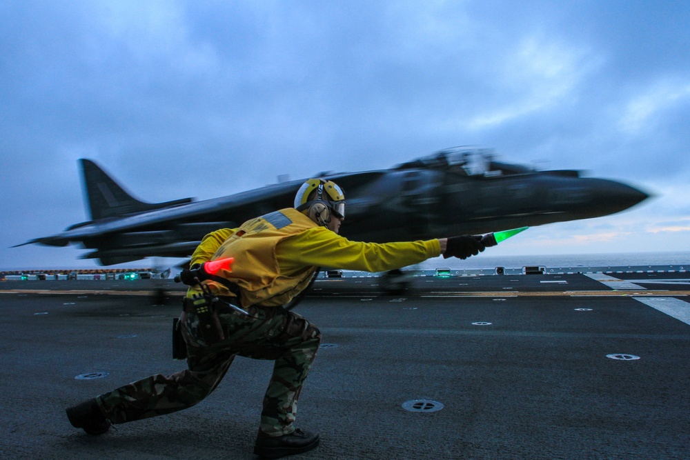 DVIDS - Images - A flight deck crewman clears an AV-8B Harrier to take off
