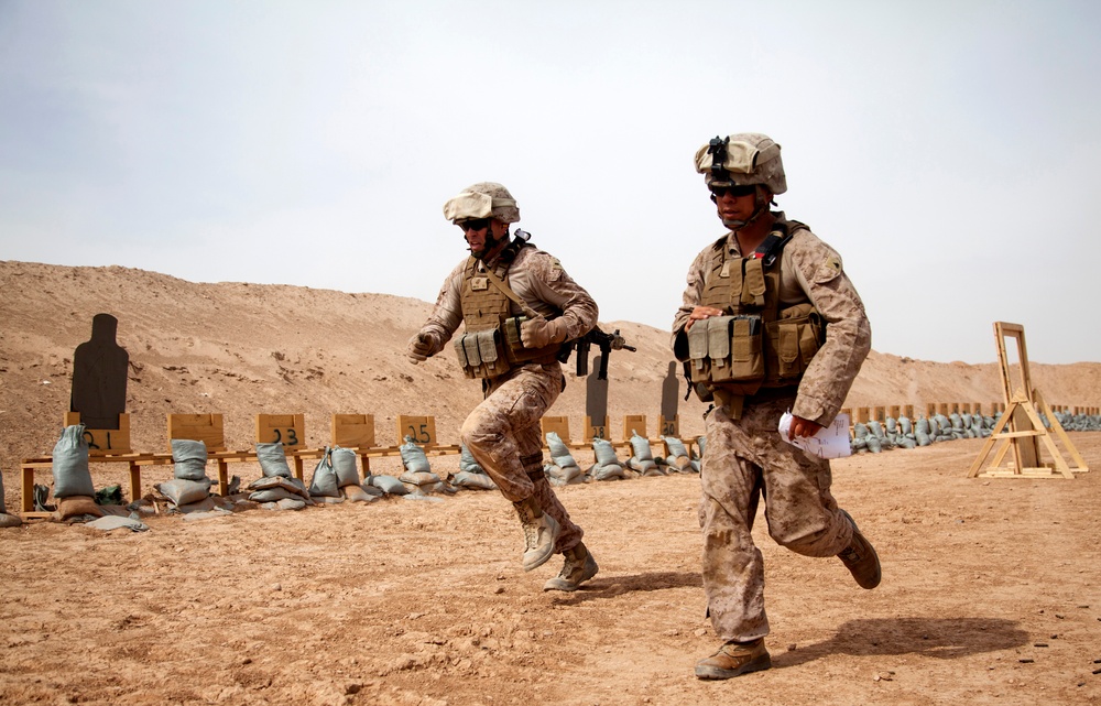 1st Lt. Bonnema and Cpl.  Barba run between stations while conducting small arms live-fire training