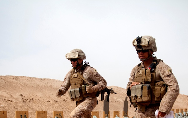 1st Lt. Bonnema and Cpl.  Barba run between stations while conducting small arms live-fire training
