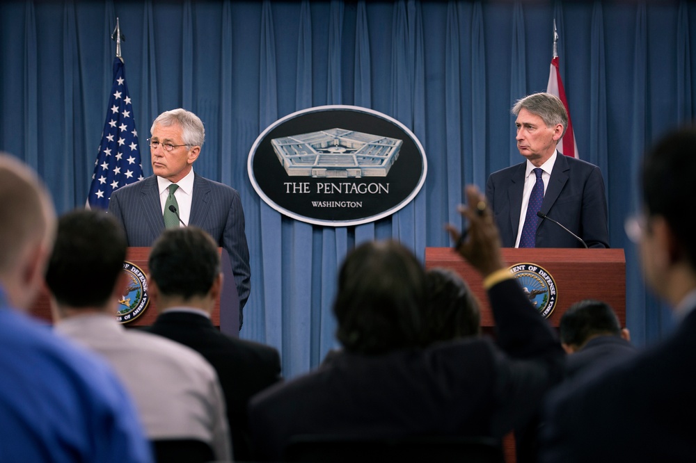 Secretary Hagel and the United Kingdom's Secretary of State for Defence Phillip Hammond listen to a reporter’s question