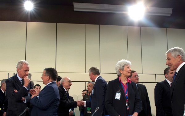 Secretary Hagel speaks with United Kingdom’s Permanent Representative Mariot Leslie at NATO headquarters in Brussels