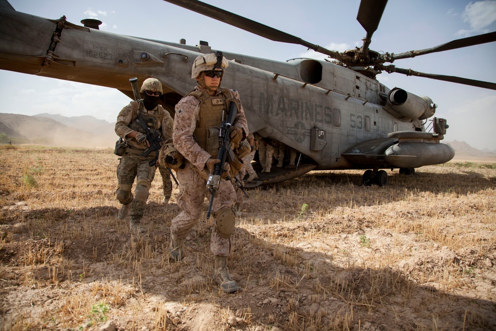 Petty Officer 3rd Class Cameron Kirk exits a U.S. Marine Corps CH-53E Super Stallion helicopter Petty Officer 3rd Class Cameron Kirk exits a U.S. Marine Corps CH-53E Super Stallion helicopter