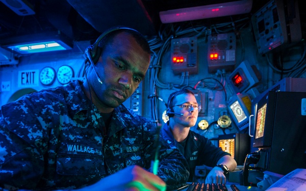 Petty Officers Wallace and Alexander observe radar signatures in the air traffic control room