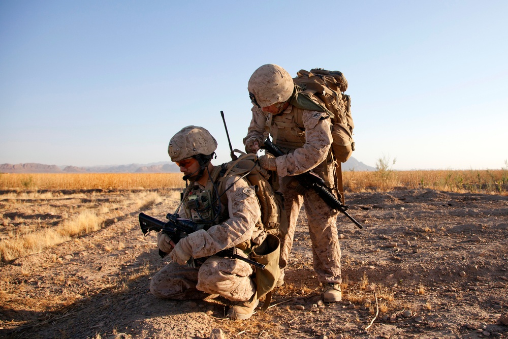 Petty Officer Arrequin adjusts Cpl. Cabral's gear