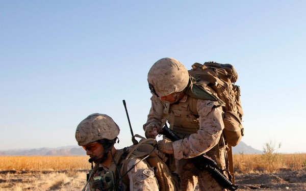 Petty Officer Arrequin adjusts Cpl. Cabral's gear