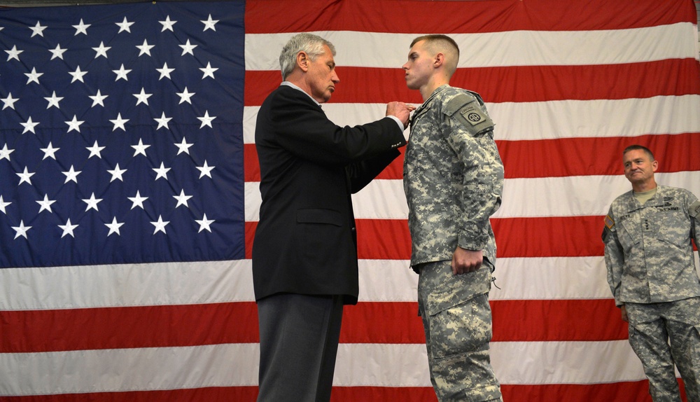 Secretary Hagel awards the Purple Heart to Spc. Trevor Hoover at Fort Bragg