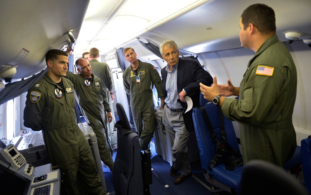 The flight crew of a U.S. Navy P-8A Poseidon briefs Secretary Hagel