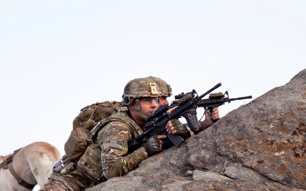 Staff Sgt. Pabey, Sgt. Carlberg and his dog Staff Sgt. Abby provide over watch from the mountaintops of Afghanistan