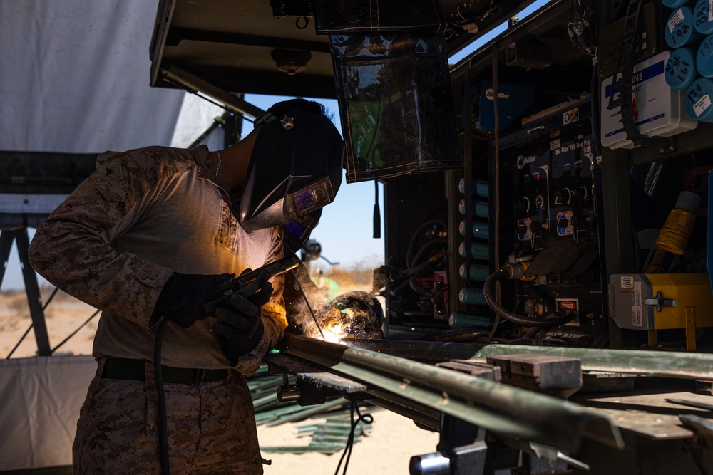 Task Force Forge Marines weld engineer stakes in preparation for barrier reinforcement