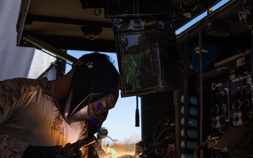 Task Force Forge Marines weld engineer stakes in preparation for barrier reinforcement