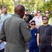 Rear Adm. Stephen Barnett, commander, Navy Region Hawaii (CNRH), speaks with community members as they wait at the Commander, U.S. Pacific Fleet (COMPACFLT) boathouse to board a boat for a guided tour.