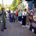 Rear Adm. Stephen Barnett, commander, Navy Region Hawaii (CNRH), speaks with community members as they wait at the Commander, U.S. Pacific Fleet (COMPACFLT) boathouse to board a boat for a guided tour.