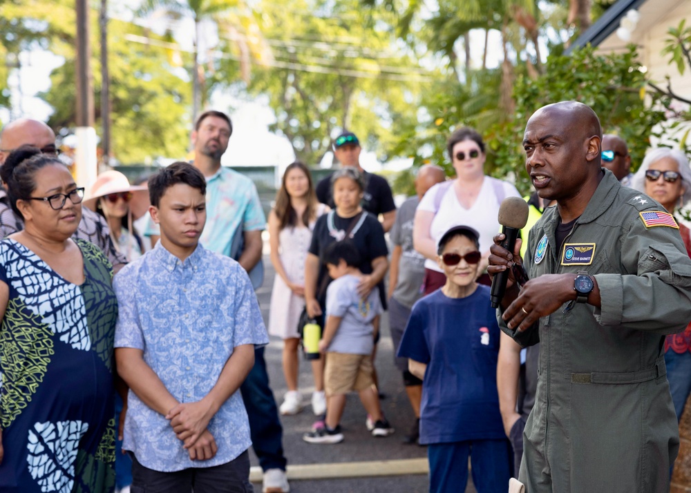 Rear Adm. Stephen Barnett, commander, Navy Region Hawaii (CNRH), speaks with community members as they wait at the Commander, U.S. Pacific Fleet (COMPACFLT) boathouse to board a boat for a guided tour.