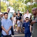 Rear Adm. Stephen Barnett, commander, Navy Region Hawaii (CNRH), speaks with community members as they wait at the Commander, U.S. Pacific Fleet (COMPACFLT) boathouse to board a boat for a guided tour.