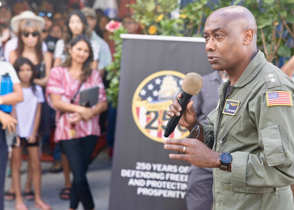 Rear Adm. Stephen Barnett, commander, Navy Region Hawaii (CNRH), speaks with community members as they wait at the Commander, U.S. Pacific Fleet (COMPACFLT) boathouse to board a boat for a guided tour.