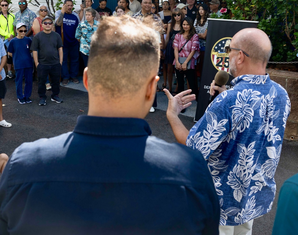 Commander, Navy Region Hawaii (CNRH) historian, James Newman, speaks with community members as they wait at the Commander, U.S. Pacific Fleet (COMPACFLT) boathouse to board a boat for a guided tour.
