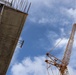 A Crane Towers Overhead During Construction on Camp Blaz