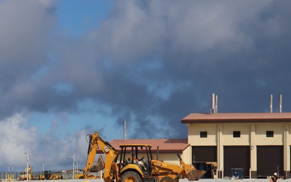 Workers Prepare the Parking Lot of an Auto Maintenance Facility for Landscaping