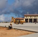 Workers Prepare the Parking Lot of an Auto Maintenance Facility for Landscaping