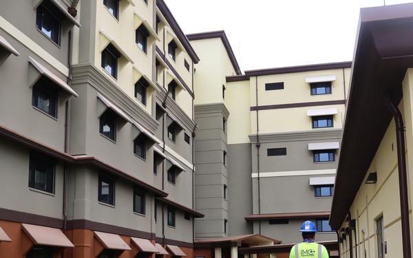 A Construction Worker Walks Alongside New Bachelor Enlisted Quarters on Camp Blaz