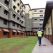 A Construction Worker Walks Alongside New Bachelor Enlisted Quarters on Camp Blaz