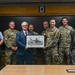 RAF Mildenhall commander Col. Garlow is presented with an award by the British Ministry of Defense