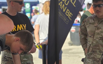&quot;Staff Sgt. Devon Nagy (left) and 1st Lt. Jeremy Lee (right) assist the York Recruiting Company during their outreach at the York Fair in York Pennsylvania.&quot;