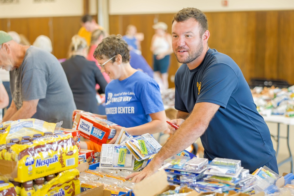 NMCB ONE Seabees Pack Youth Food Bags During Navy Week